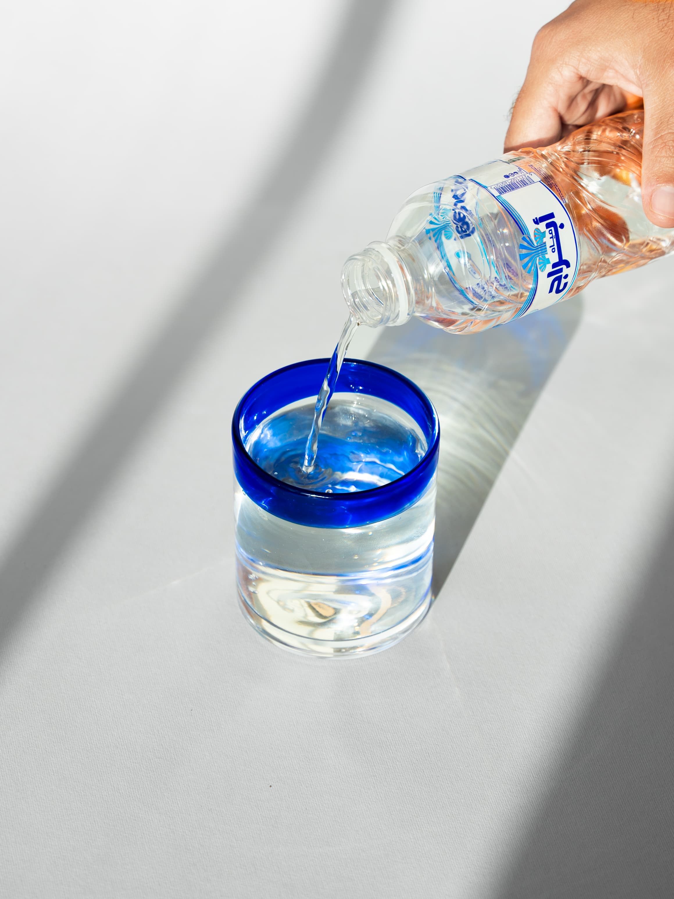 Pouring Abraaj Water into a glass